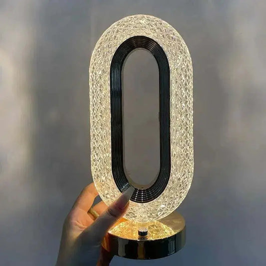 Elegant crystal LED lamp with geometric facets creating prismatic light effects on modern bedside table, showcasing contemporary interior design and ambient lighting